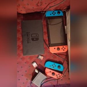 Nintendo Handheld Console with Blue and Red Controllers